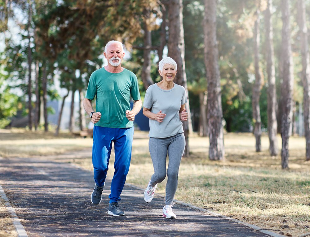 smiling,active,mature,senior,couple,jogging,together,in,the,park